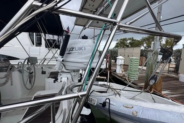Slide: The Image of Beneteau 50 sailboat from 1996 with Suzuki outboard motor at dock. - 4