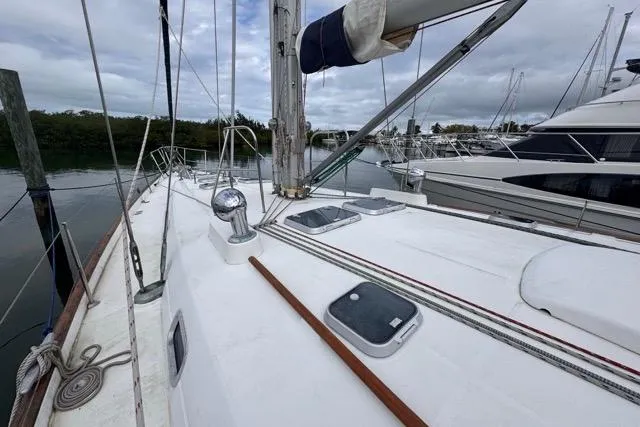 Slide: The Image of 1996 Beneteau 50 sailboat deck with rigging, docked in a marina. - 15