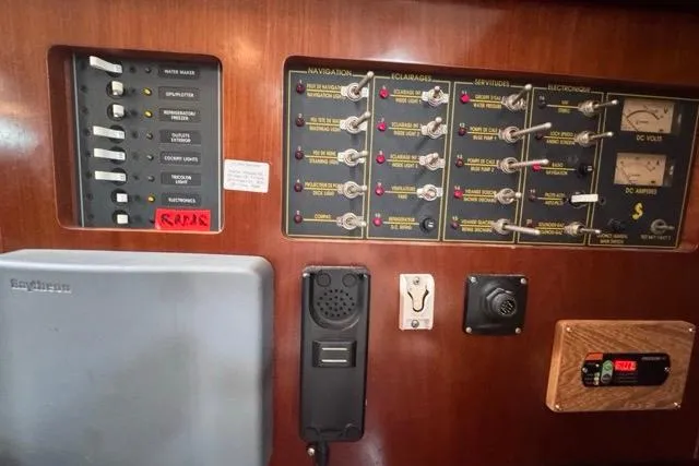 Slide: The Image of Control panel of a 1996 Beneteau 50 yacht, featuring navigation and electrical systems. - 75