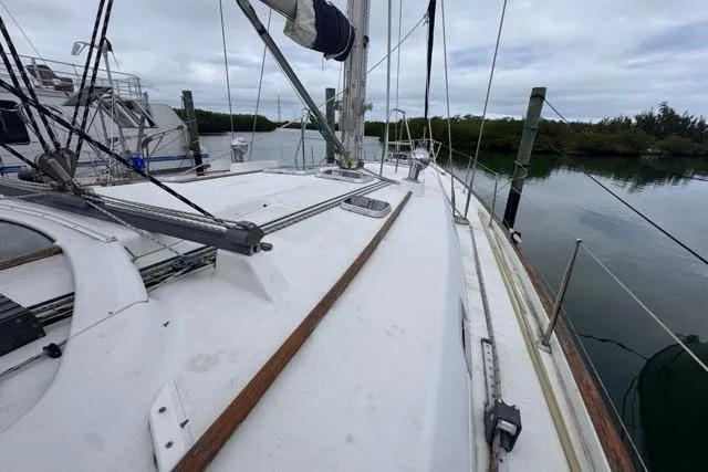 Slide: The Image of Sailboat deck view of a 1996 Beneteau 50, docked in a serene marina. - 35