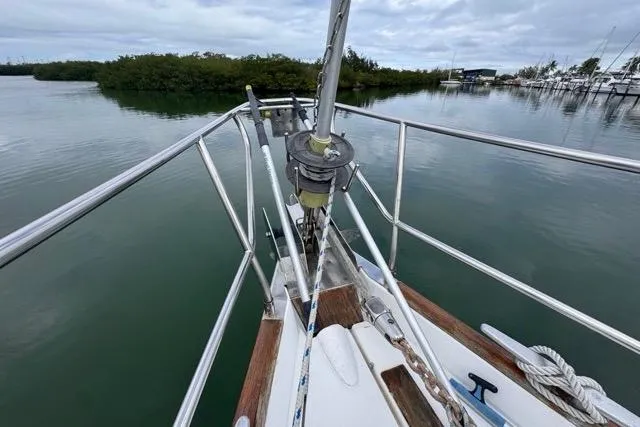 Slide: The Image of Bow of 1996 Beneteau 50 sailboat with railing, anchored in calm waters. - 23