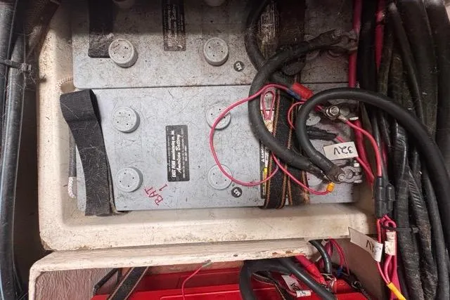 Slide: The Image of Battery compartment of a 1996 Beneteau 50 sailboat with wiring and connections. - 112