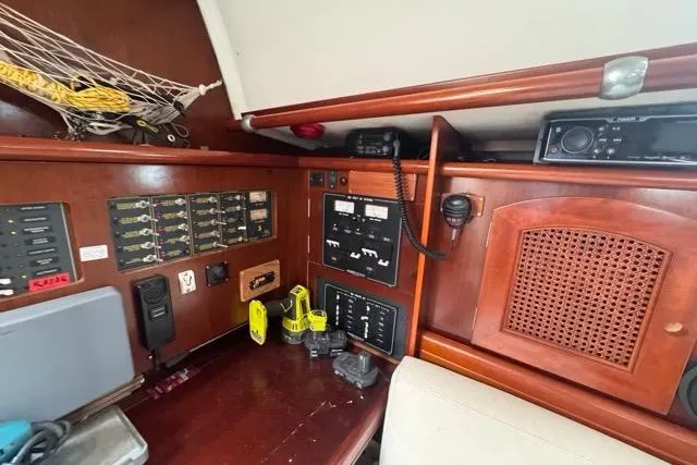 Slide: The Image of Navigation station of a 1996 Beneteau 50 yacht with control panels and equipment. - 74