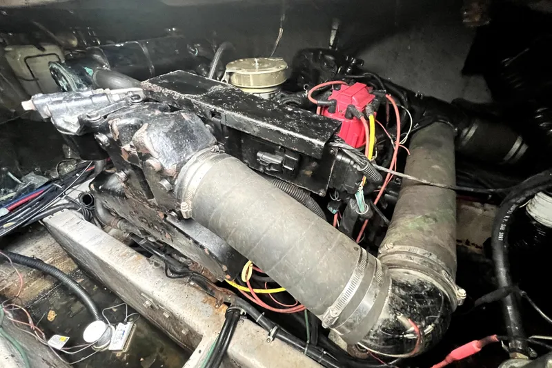 Slide: The Image of Engine compartment of a 1996 Wellcraft 330 Coastal boat, showing mechanical components and wiring. - 62