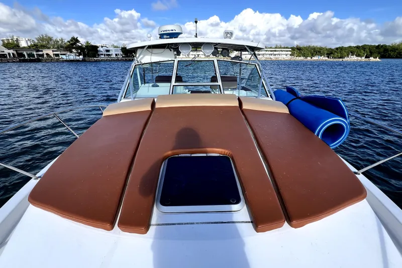 Slide: The Image of 1996 Wellcraft 330 Coastal boat with brown deck cushions on a sunny day. - 40