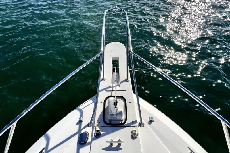 Slide: The Image of Bow view of 1996 Wellcraft 330 Coastal boat on sparkling water. - 38