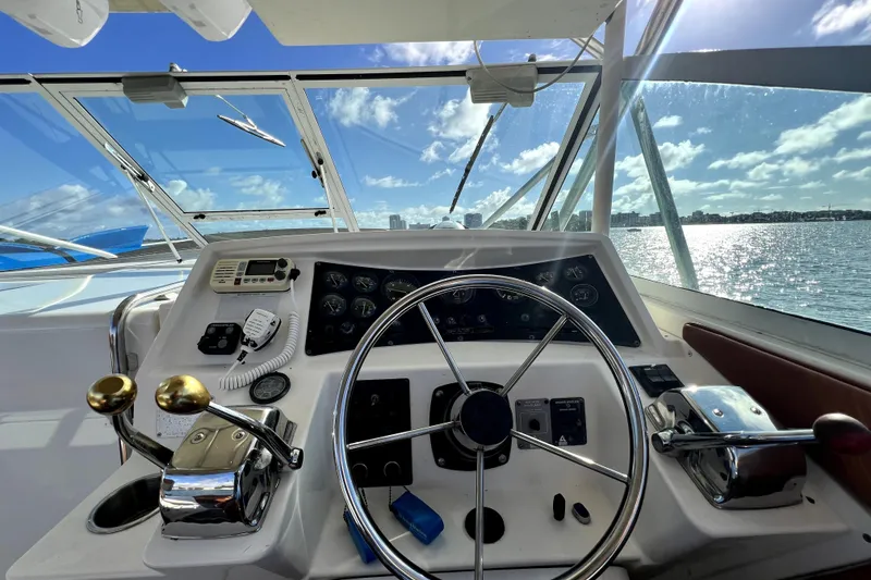 Slide: The Image of Helm of 1996 Wellcraft 330 Coastal boat with ocean view and clear sky. - 49