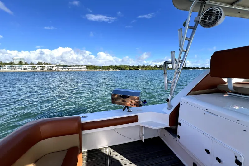 Slide: The Image of 1996 Wellcraft 330 Coastal boat interior with scenic water view and clear blue sky. - 28