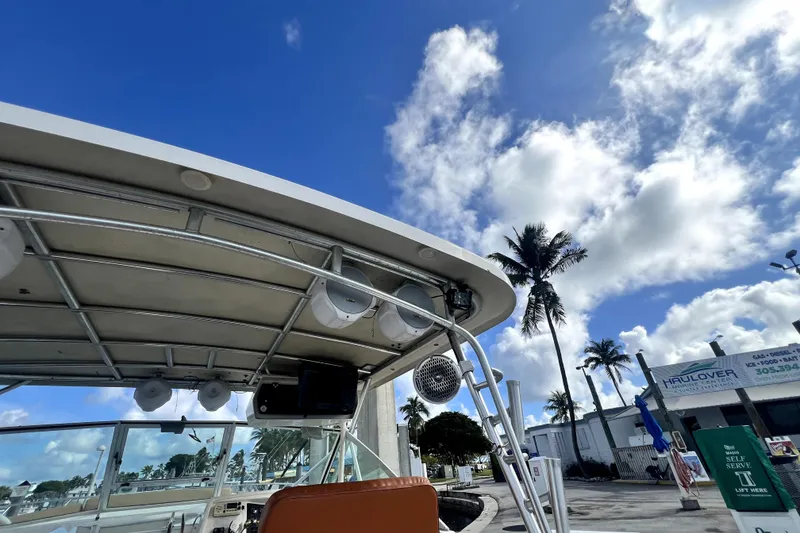 Slide: The Image of 1996 Wellcraft 330 Coastal boat docked under a clear blue sky with palm trees. - 31