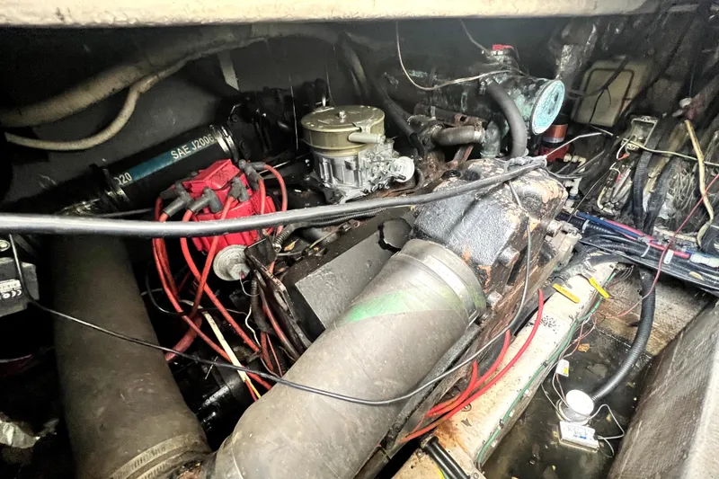 Slide: The Image of Engine compartment of a 1996 Wellcraft 330 Coastal boat, showing mechanical components and wiring. - 61