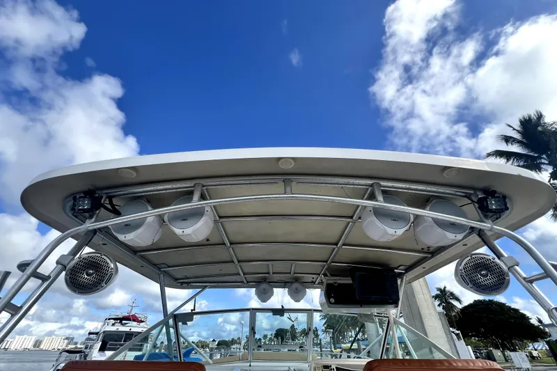 Slide: The Image of 1996 Wellcraft 330 Coastal boat roof with speakers against blue sky. - 30