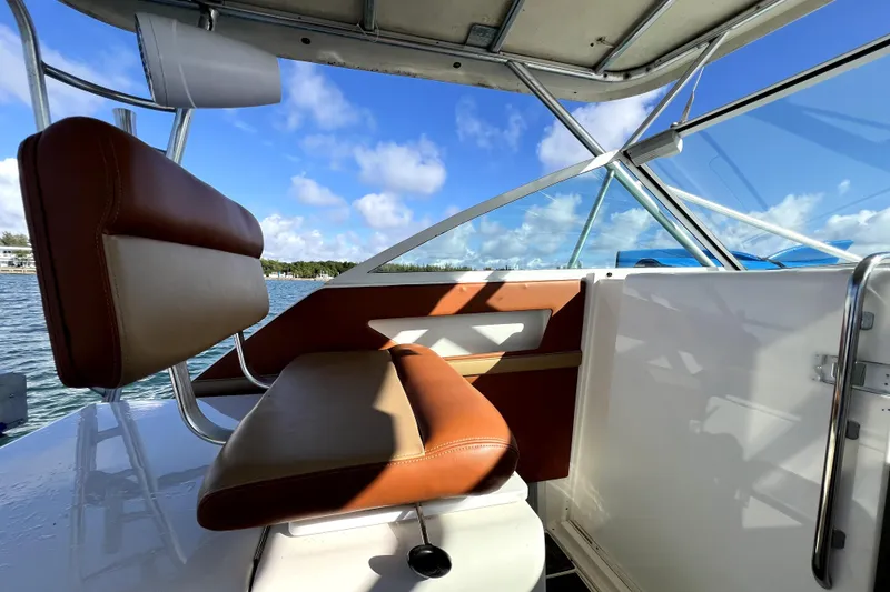 Slide: The Image of Interior view of 1996 Wellcraft 330 Coastal boat with brown seating and clear skies. - 42