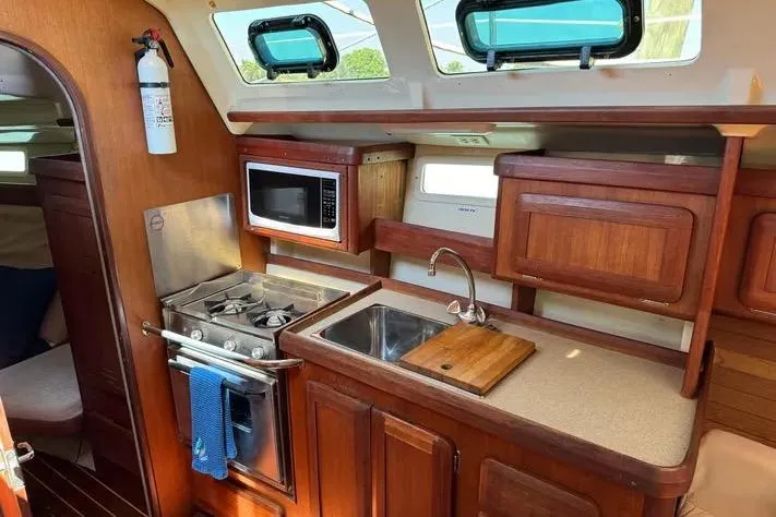 Slide: The Image of Cozy kitchen in 1993 Hunter Vision 36 sailboat with stove, sink, and microwave. - 13
