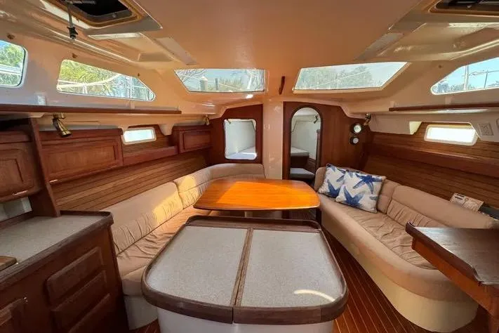 Slide: The Image of Interior of 1993 Hunter Vision 36 sailboat with cozy seating and wooden accents. - 15