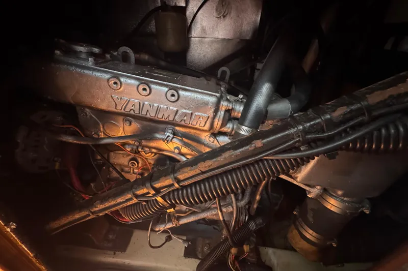 Slide: The Image of Yanmar engine inside a 1992 Hunter Passage 42 sailboat, showing detailed components and wiring. - 92