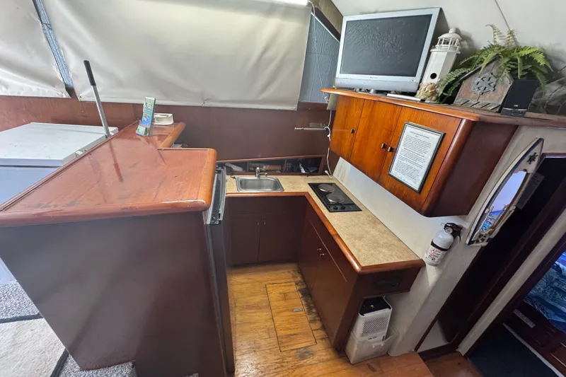 Slide: The Image of Interior of 1991 Ocean Yachts 35 Super Sport with kitchen and wooden cabinetry. - 39
