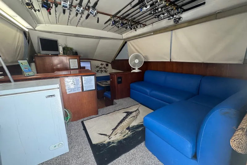 Slide: The Image of Interior of 1991 Ocean Yachts 35 Super Sport with blue seating and fishing rods. - 33