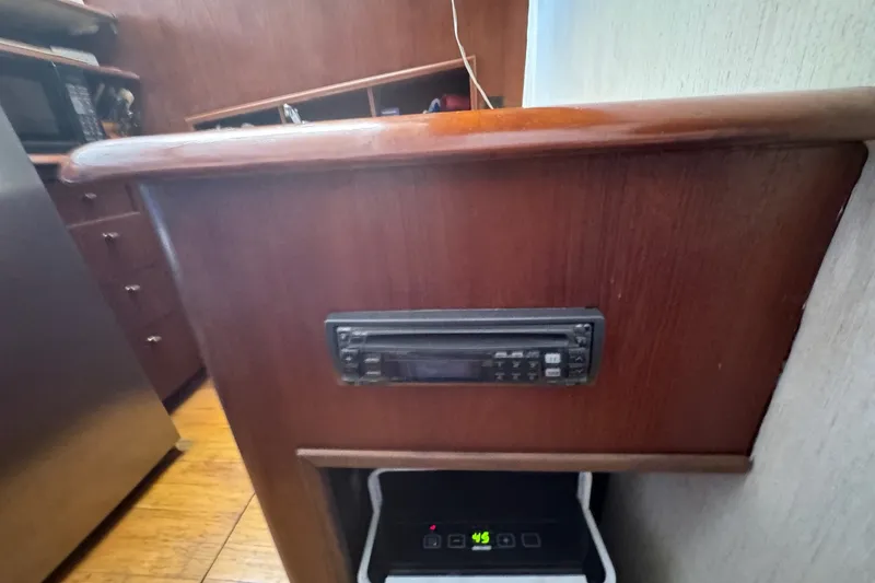 Slide: The Image of Interior of 1991 Ocean Yachts 35 Super Sport with wooden cabinetry and built-in stereo system. - 38