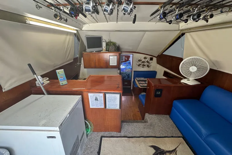 Slide: The Image of Interior of 1991 Ocean Yachts 35 Super Sport with fishing rods, seating, and fan. - 34