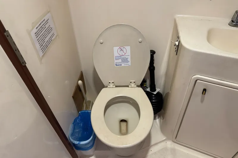 Slide: The Image of Toilet and sink in 1991 Ocean Yachts 35 Super Sport bathroom. - 53