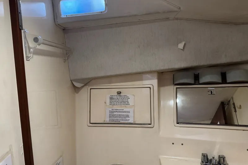 Slide: The Image of Interior of 1991 Ocean Yachts 35 Super Sport bathroom with mirror and sink. - 55