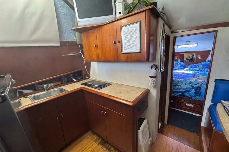 Slide: The Image of 1991 Ocean Yachts 35 Super Sport interior with kitchen and cozy bedroom. - 62