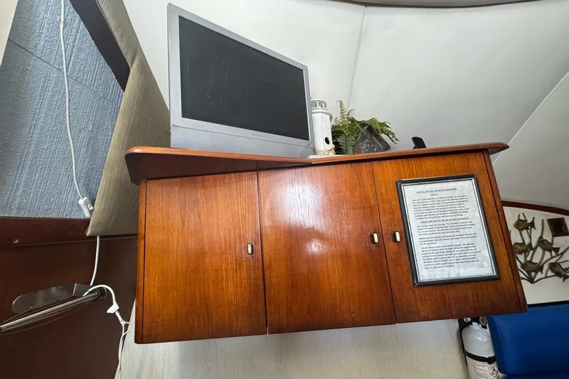 Slide: The Image of Interior of 1991 Ocean Yachts 35 Super Sport with wooden cabinet and mounted TV. - 63
