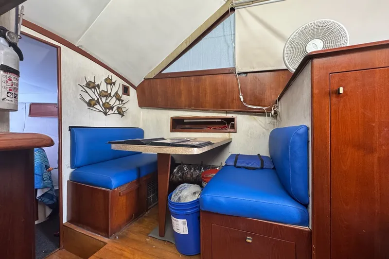 Slide: The Image of Interior of 1991 Ocean Yachts 35 Super Sport with blue seating and wooden accents. - 48