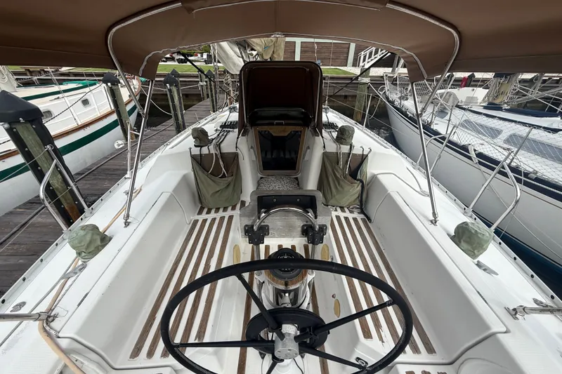 Slide: The Image of Cockpit of 1990 Beneteau First 35s5 sailboat with steering wheel and canopy. - 11