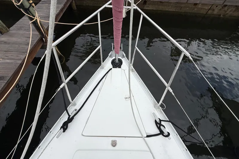 Slide: The Image of Bow view of a 1990 Beneteau First 35s5 sailboat docked at a marina. - 32