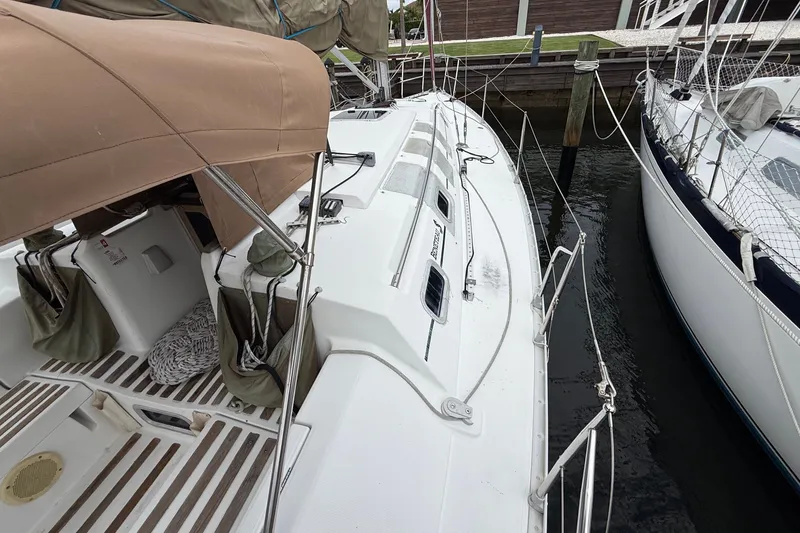 Slide: The Image of 1990 Beneteau First 35s5 sailboat docked, featuring deck and cockpit view. - 22