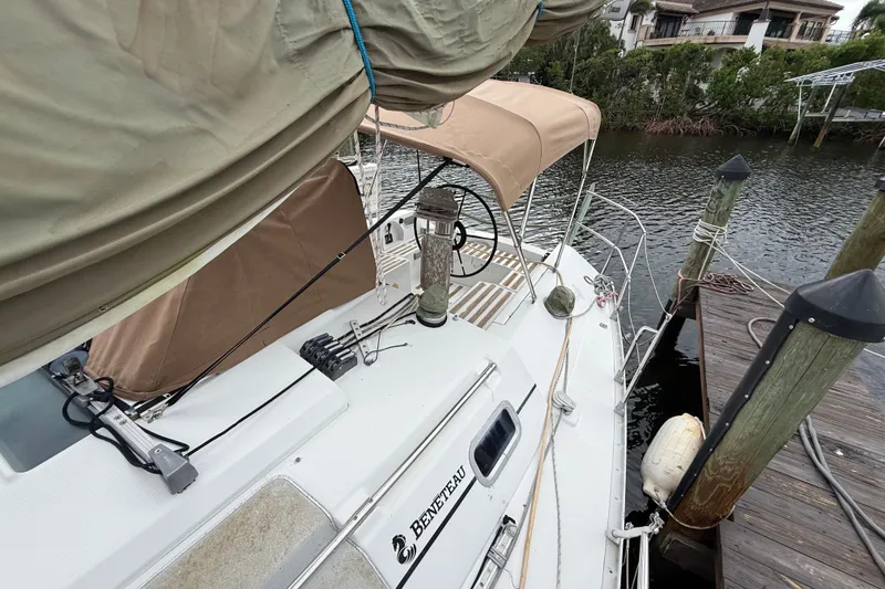 Slide: The Image of Beneteau First 35s5 sailboat docked, showcasing deck and helm, 1990 model. - 41