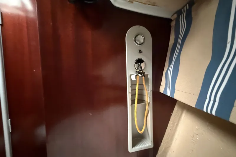 Slide: The Image of Interior of a 1990 Beneteau First 35s5 sailboat, featuring a wooden panel and nautical decor. - 95