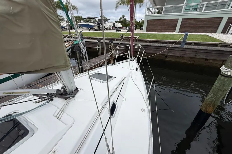 Slide: The Image of 1990 Beneteau First 35s5 sailboat docked at marina, view of deck and mast. - 28