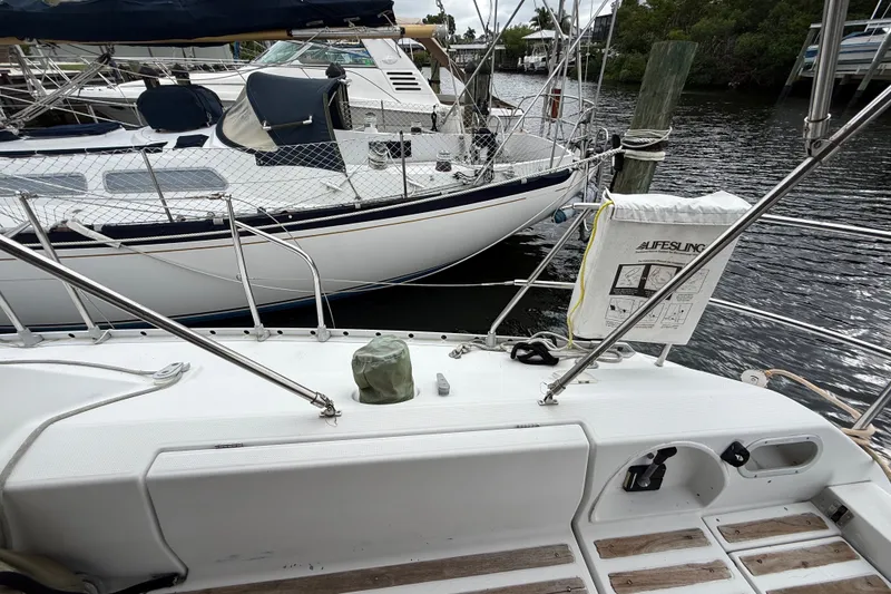 Slide: The Image of Beneteau First 35s5 sailboat docked, featuring deck details and Lifesling safety equipment. - 21