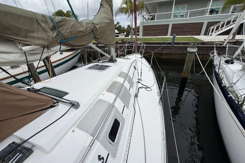 Slide: The Image of 1990 Beneteau First 35s5 sailboat docked at marina, view of deck and rigging. - 24