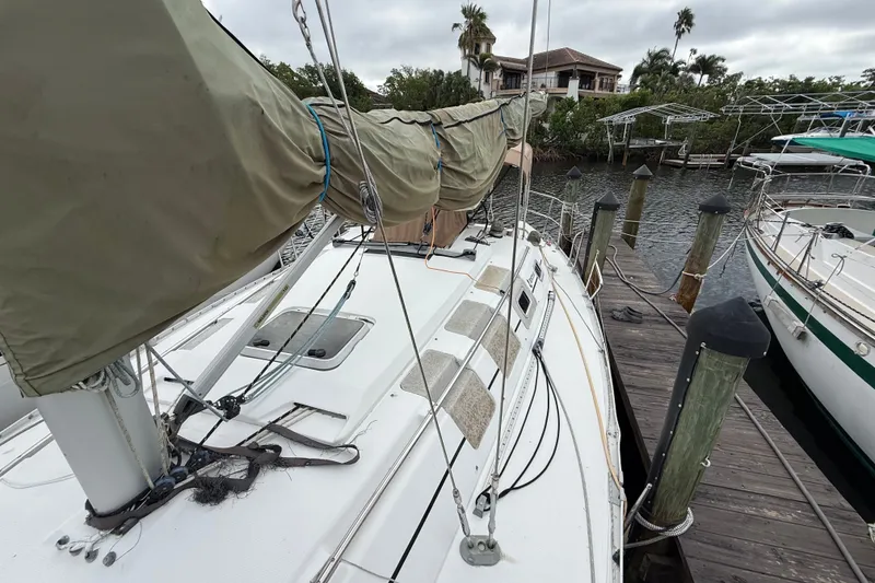 Slide: The Image of 1990 Beneteau First 35s5 sailboat docked, showing deck and rigging details. - 38