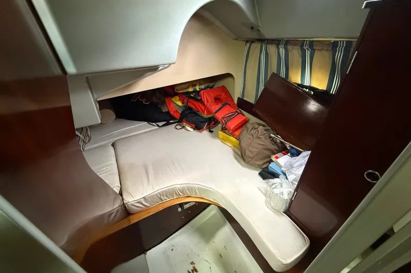 Slide: The Image of Cozy cabin interior of 1990 Beneteau First 35s5 sailboat with storage and bedding. - 61