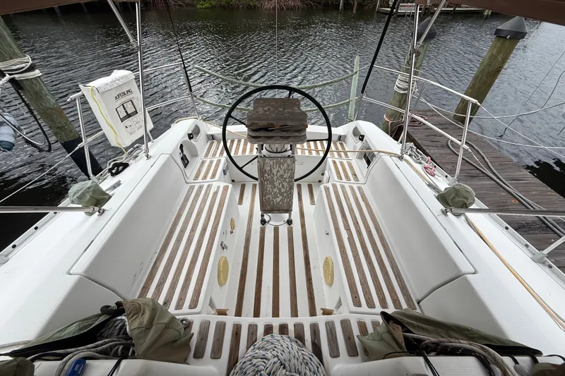 Slide: The Image of Cockpit of a 1990 Beneteau First 35s5 sailboat with wooden flooring and steering wheel. - 43