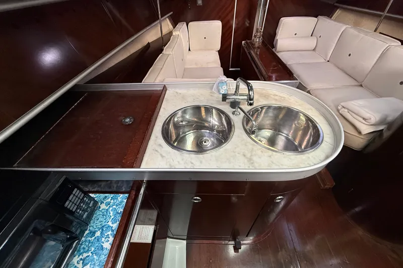 Slide: The Image of Interior of 1990 Beneteau First 35s5 yacht with dual sinks and cozy seating area. - 66