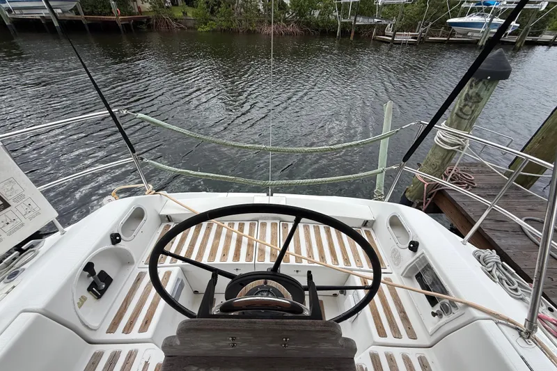 Slide: The Image of Cockpit view of a 1990 Beneteau First 35s5 sailboat docked by the water. - 46