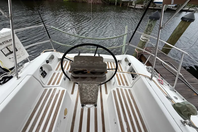 Slide: The Image of Cockpit of 1990 Beneteau First 35s5 sailboat with wooden accents and steering wheel. - 45