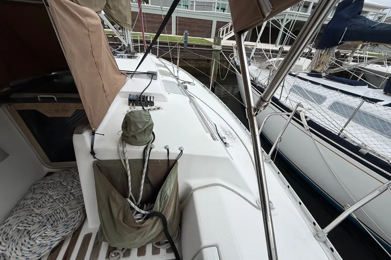 Slide: The Image of Beneteau First 35s5 sailboat deck, 1990 model, docked with visible rigging and equipment. - 20