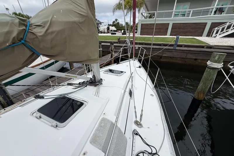 Slide: The Image of 1990 Beneteau First 35s5 sailboat docked, showcasing deck and rigging details. - 27