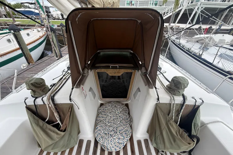 Slide: The Image of Cockpit view of 1990 Beneteau First 35s5 sailboat with ropes and storage bags. - 18