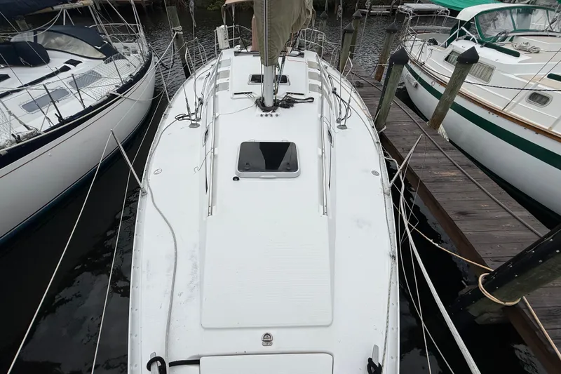 Slide: The Image of 1990 Beneteau First 35s5 sailboat docked, top view showing deck and rigging. - 34