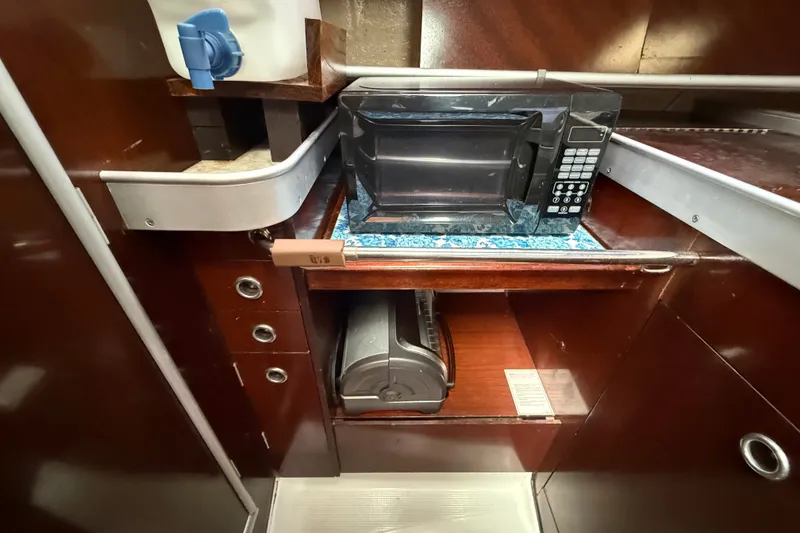 Slide: The Image of Galley of 1990 Beneteau First 35s5 yacht with microwave and storage. - 56
