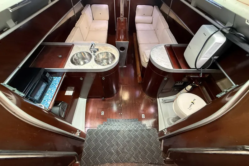 Slide: The Image of Interior of 1990 Beneteau First 35s5 yacht with kitchen, seating, and bathroom. - 53