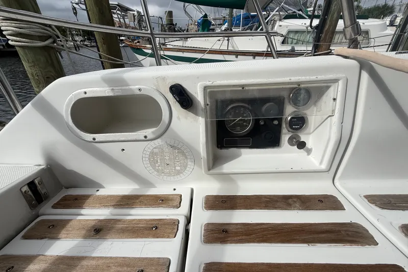 Slide: The Image of Cockpit of 1990 Beneteau First 35s5 sailboat with control panel and wooden flooring. - 8