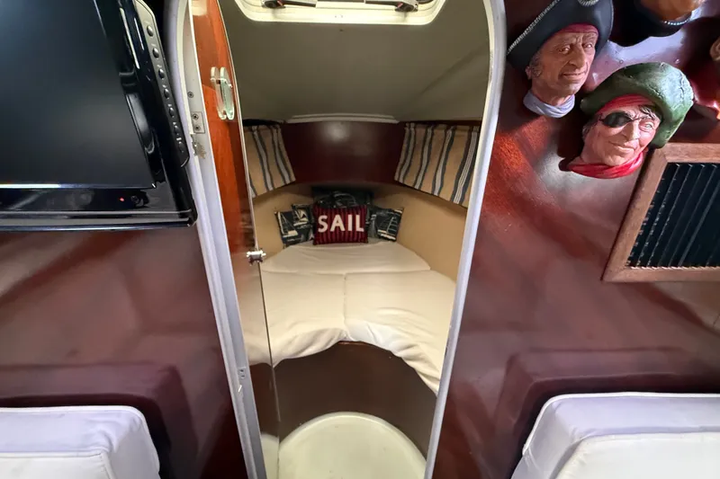 Slide: The Image of Interior cabin of 1990 Beneteau First 35s5 sailboat with cozy bed and nautical decor. - 90